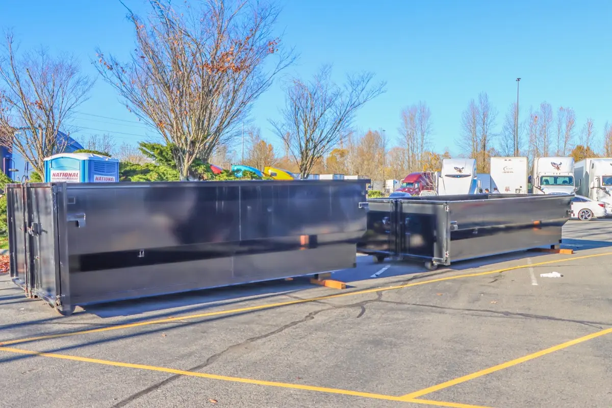 Professional dumpster rental service with roll-off container on residential driveway in Los Lunas